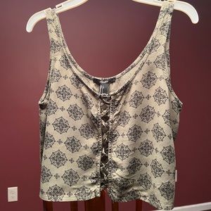 Crop top with cut out center. Green with medallions.